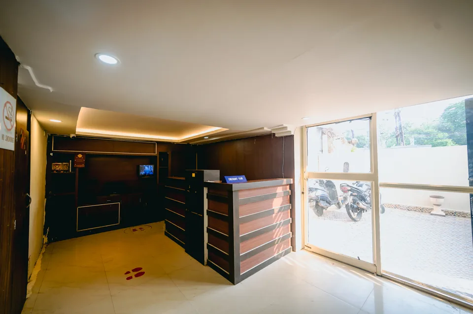 Reception area with glass entrance door at Hotel Laughing Buddha 2